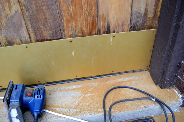 Sanding a wood front door