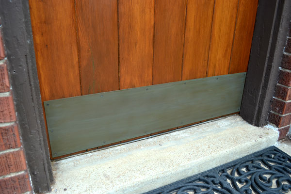 Faux painted brass patina on door kickplate