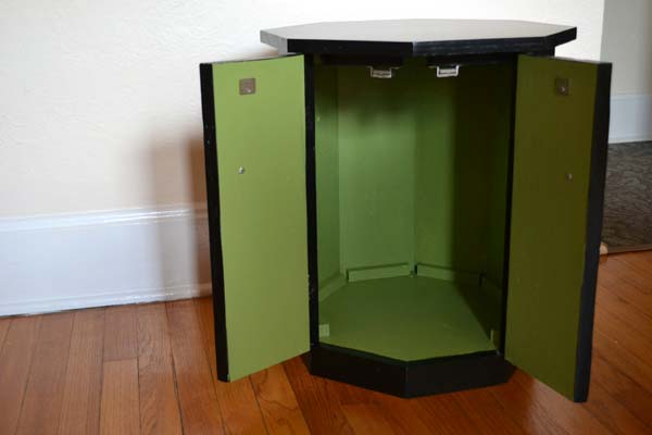 Black painted octagonal end table with green interior