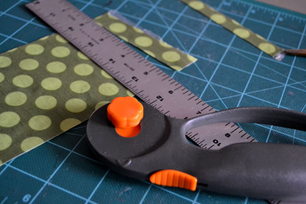 Trimming fabric with rotary cutter