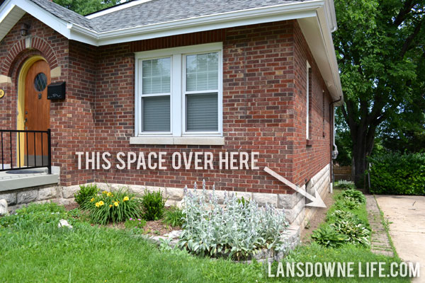 Landscaping bed with hostas on side of house