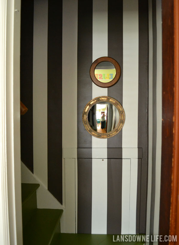 Stairway makeover reveal with green painted stairs and black and white wall stripes