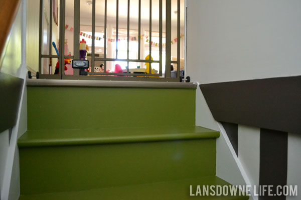 Stairway makeover reveal with green painted stairs and black and white wall stripes