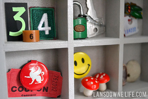 Dollhouse bookshelf filled with miniature collected treasures