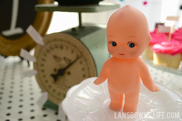 Vintage kewpie doll as a first birthday party decoration