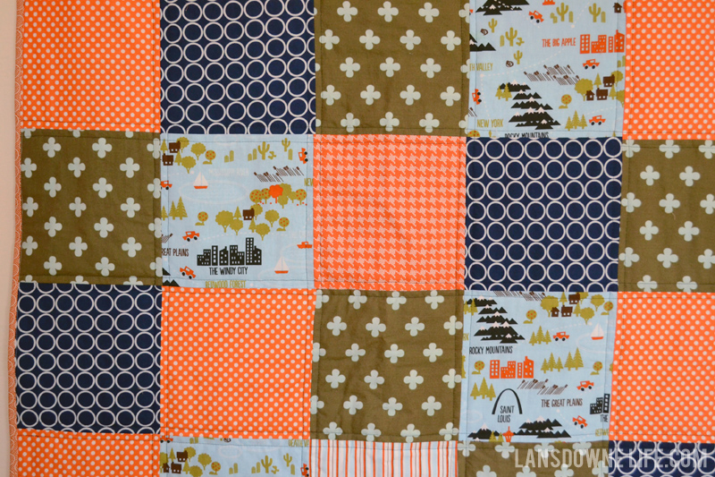 Orange, navy, and olive patchwork baby boy quilt