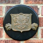 Curb appeal detail: Brass griffin shield plaque