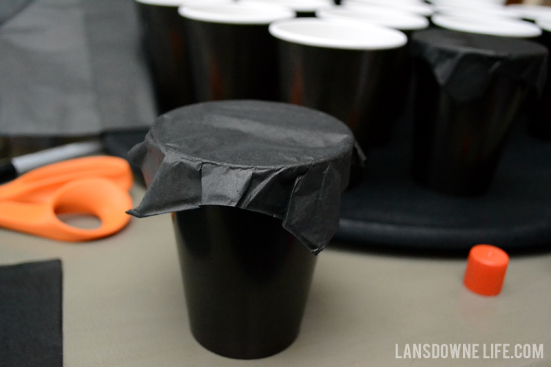 Wrap tissue paper on top of the cups